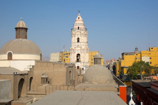 A historic building with a bell tower and dome, surrounded by urban buildings.