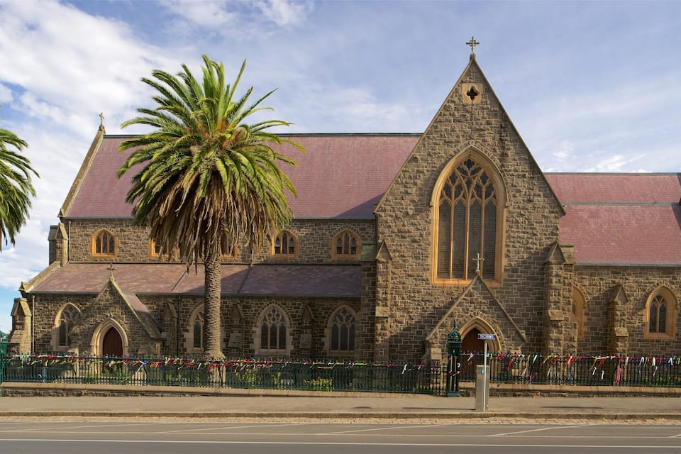 A historic church with a pointed steeple and arched windows.