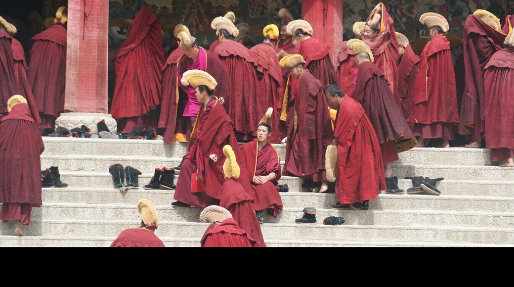 Monks entering the Main Temple. Labrang is the biggest lamasery of the Yellow Hat Sect outside Tibet