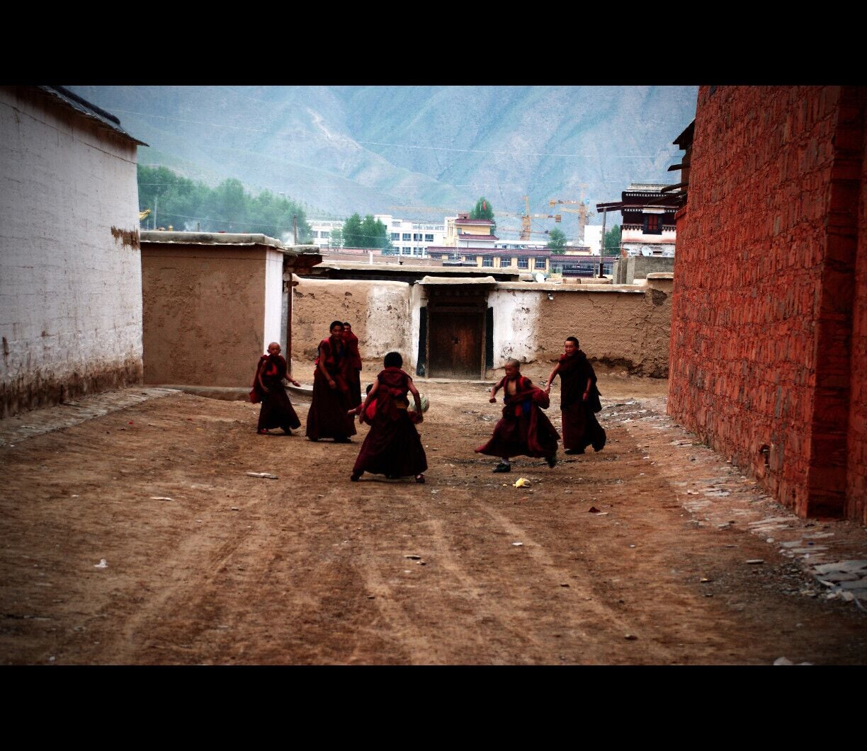 Young monks playing football