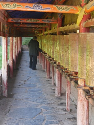 Pilgrim walking the kora at Milarepa Palace.