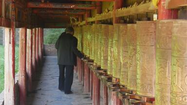 Pilgrim walking the kora at Milarepa Palace.