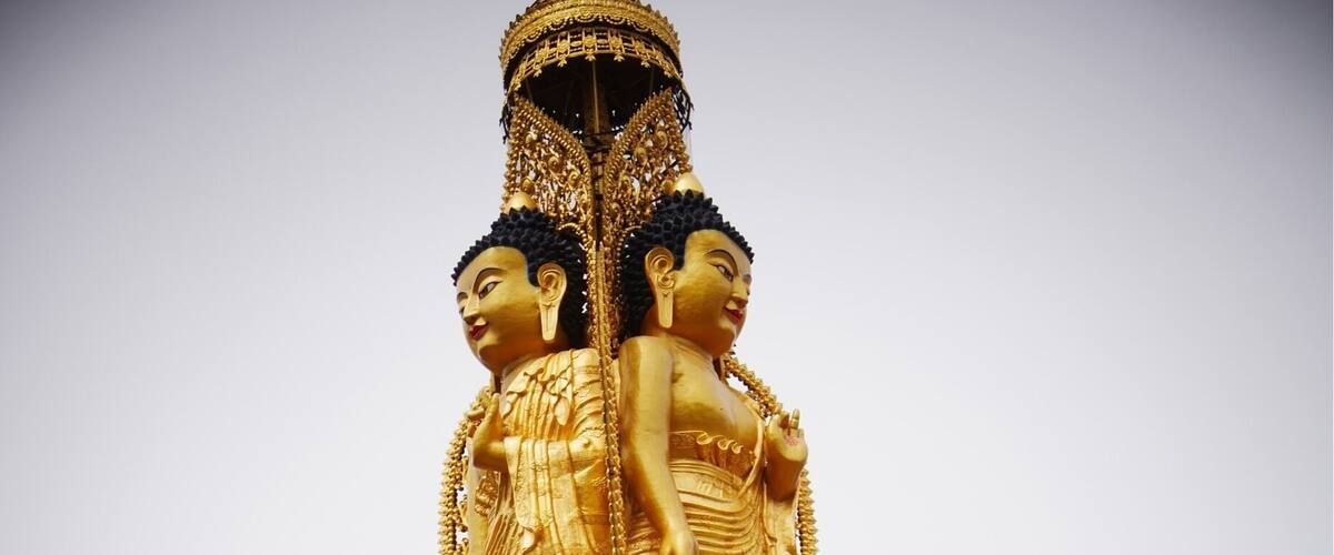 Two faces of a triple Buddha at the Lower Wutan Monastery, Rebkong, China.