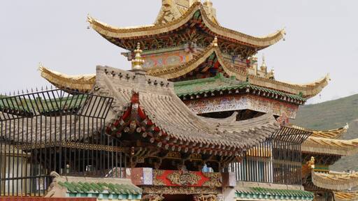 Gilded and stone rooftops at the Longwu Monastery, Rebkong, China.