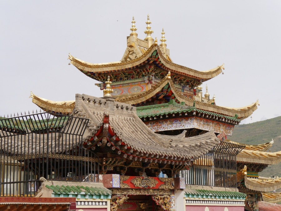 Gilded and stone rooftops at the Longwu Monastery, Rebkong, China.