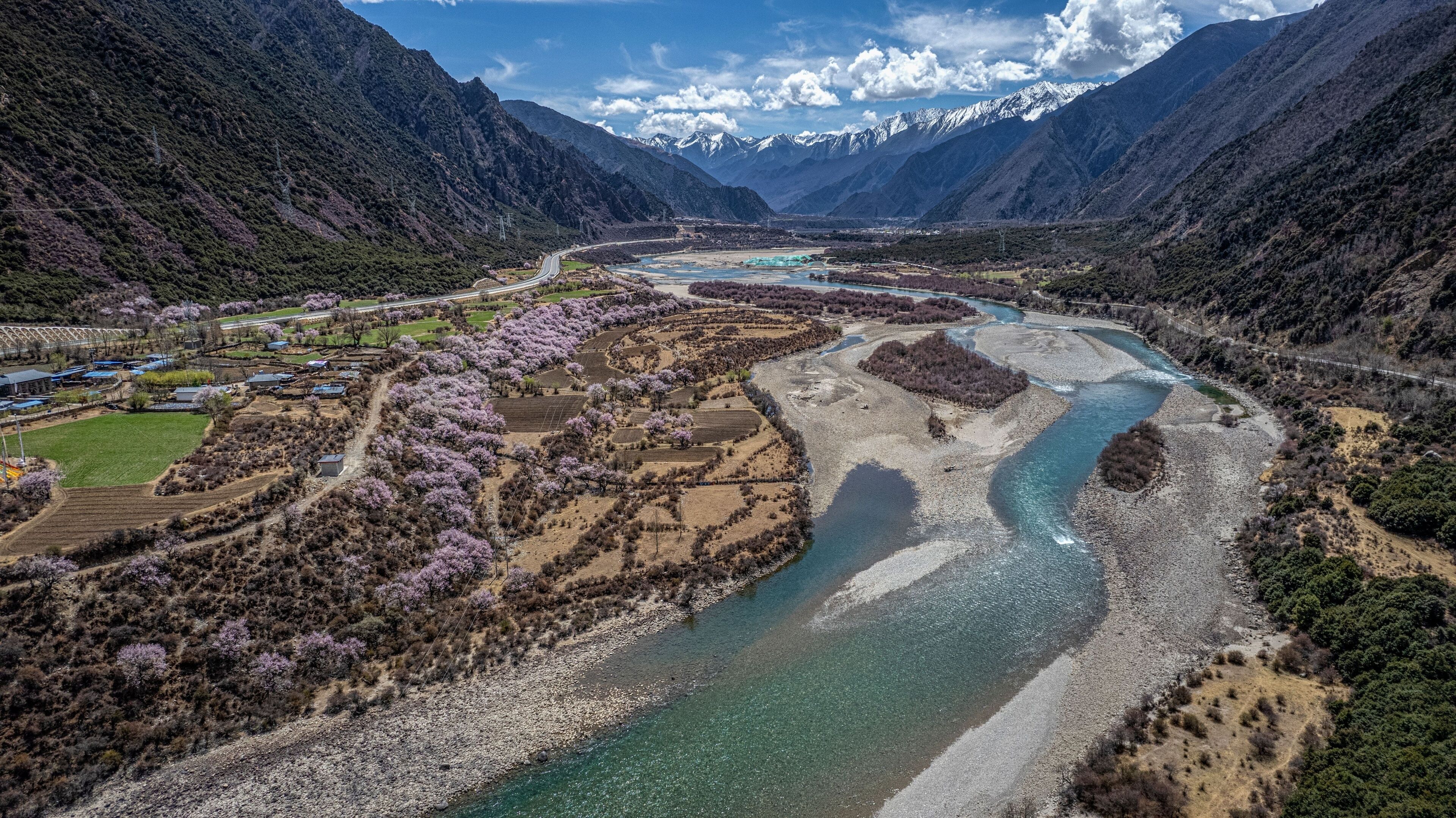 Niyang river with a background of alpine mountains in Tibet