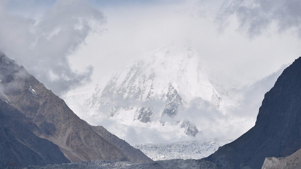 A glacier with snow-covered peaks in the background.