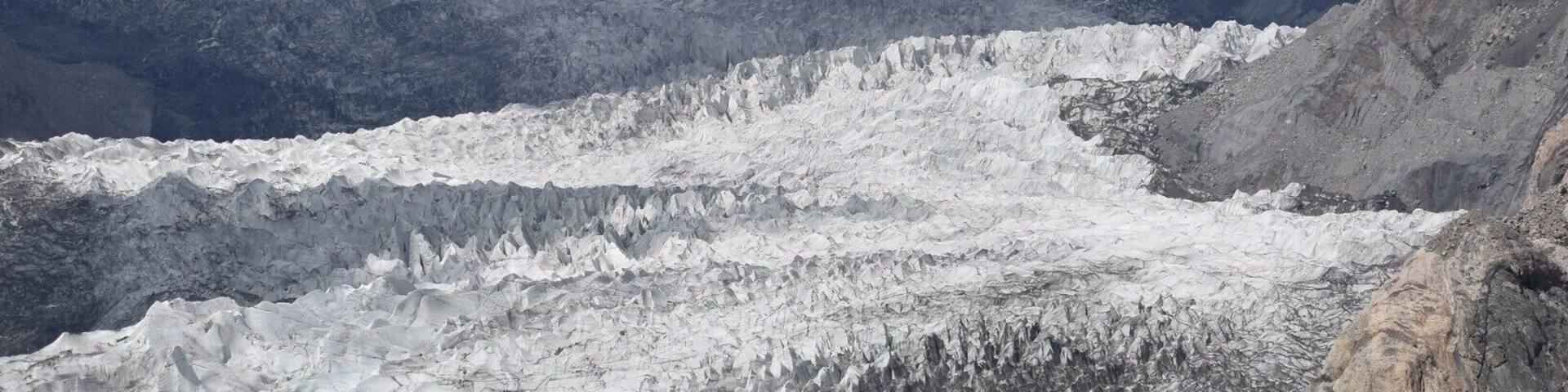 A glacier with snow-covered peaks in the background.