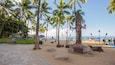 Duke Kahanamoku Statue which includes a statue or sculpture, a beach and tropical scenes