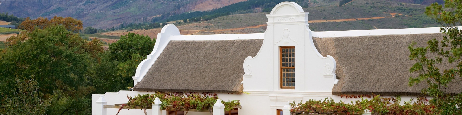 Babylonstoren which includes mountains and a small town or village
