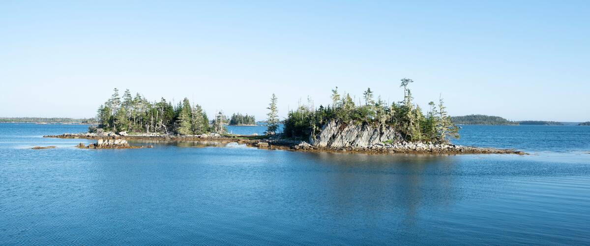 Canada, Nova Scotia, Mitchell Bay, Clear sky over small forested islands
