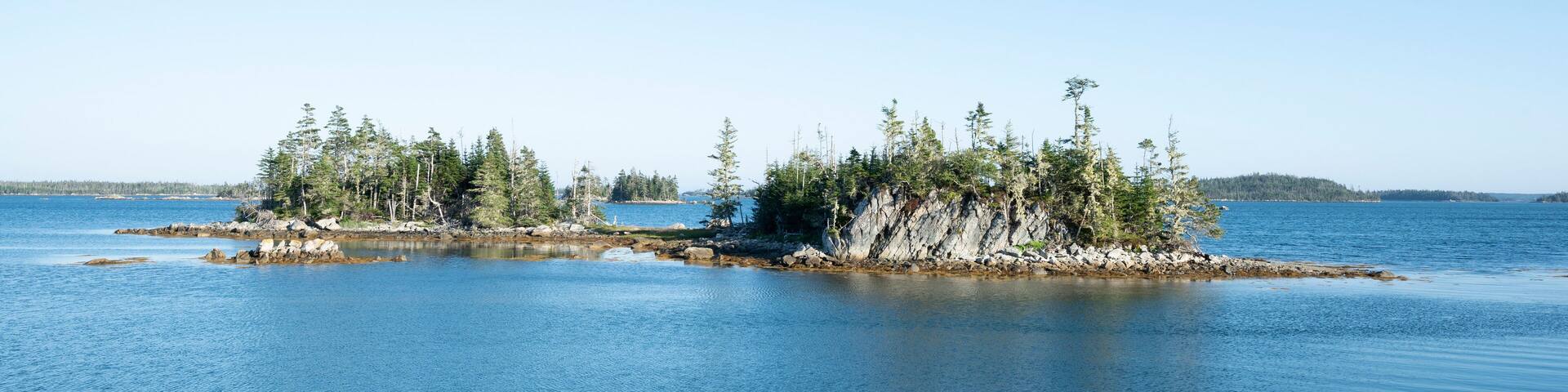 Canada, Nova Scotia, Mitchell Bay, Clear sky over small forested islands