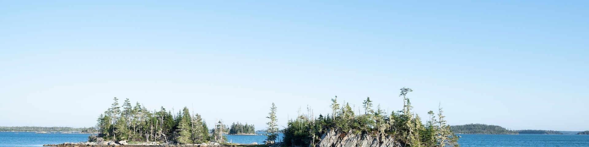 Canada, Nova Scotia, Mitchell Bay, Clear sky over small forested islands