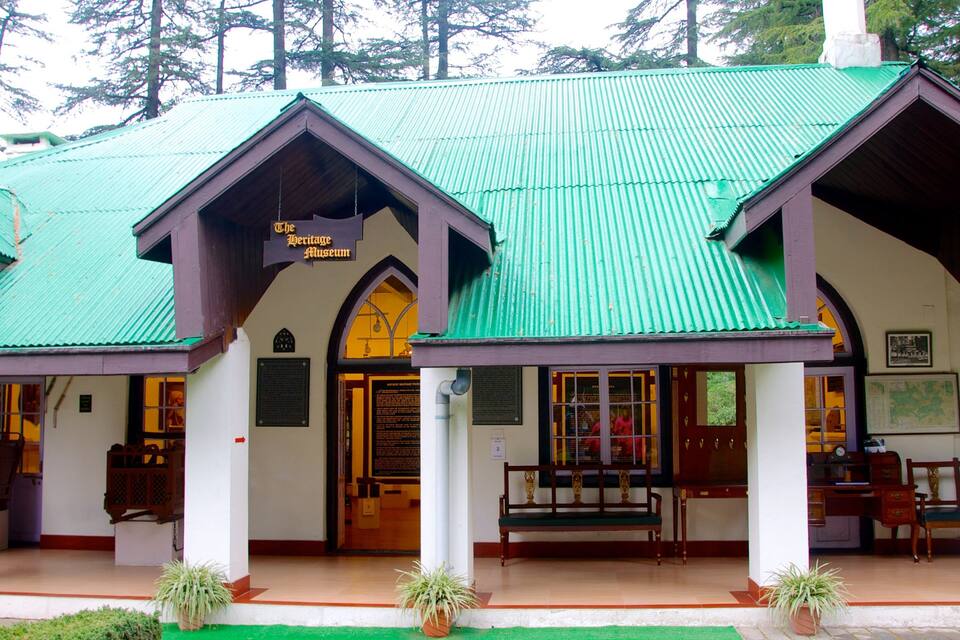 A heritage museum with a green roof and wooden architecture.