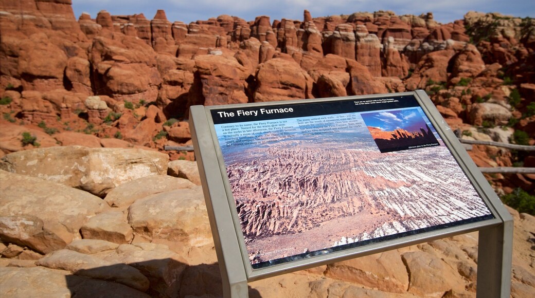 Arches National Park featuring desert views, a gorge or canyon and signage