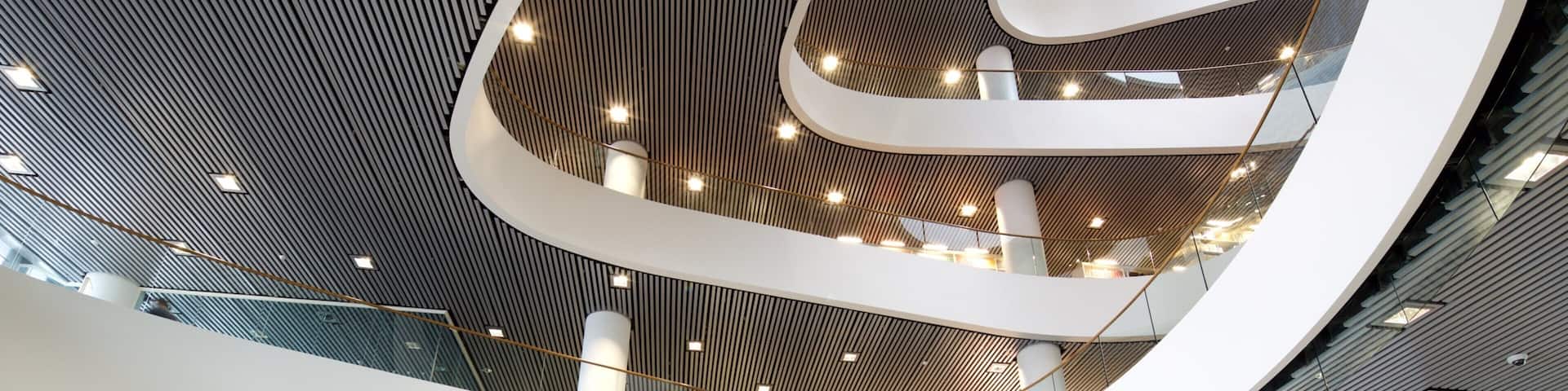 A modern architectural structure with a curved ceiling and multiple levels.
