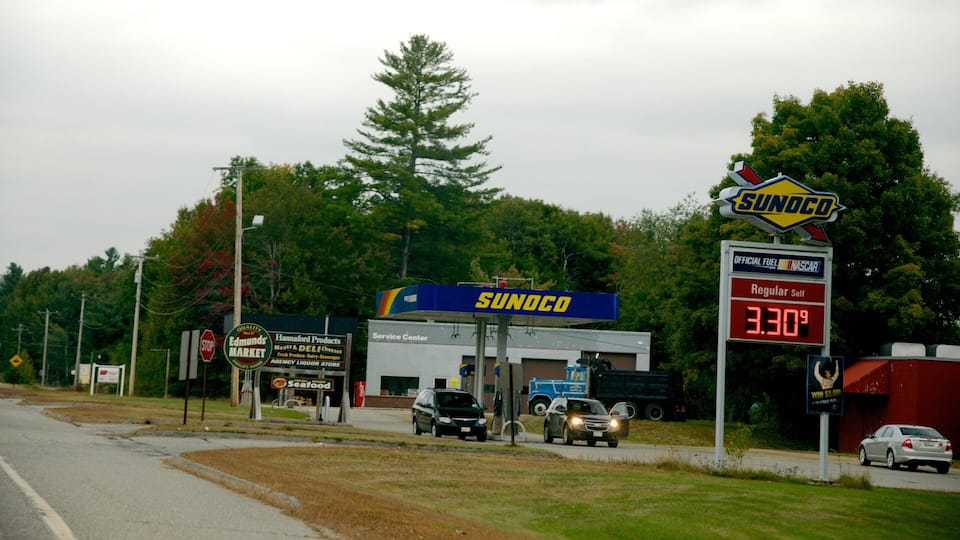 A gas station with a 'SUNOCO' sign, a 'Service Center' building, and a 'Hannaford Products' store.