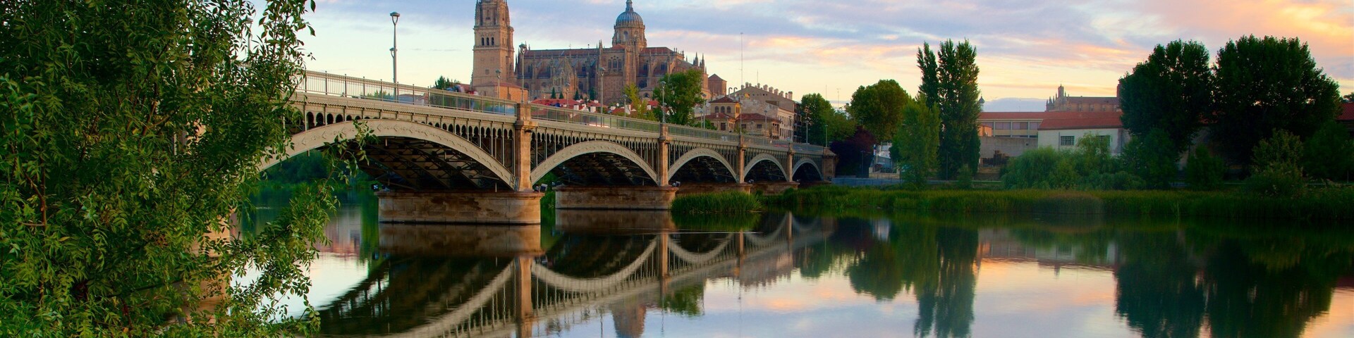 Enrique Estevan Bridge featuring a river or creek, a bridge and a sunset