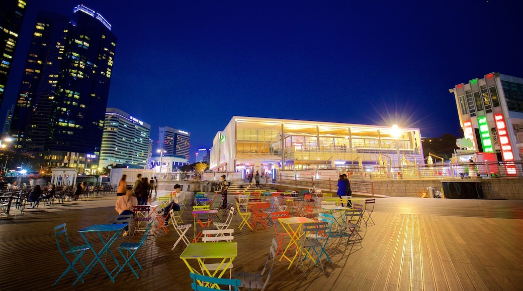 Busan which includes a city and night scenes as well as a small group of people