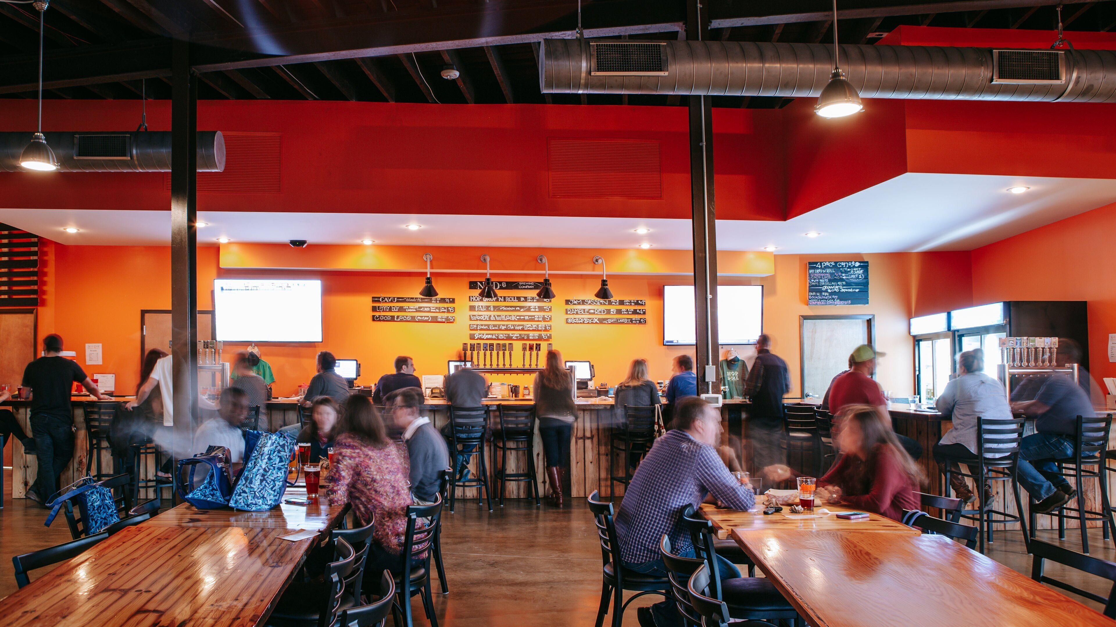 NoDa Brewing Company showing interior views as well as a small group of people