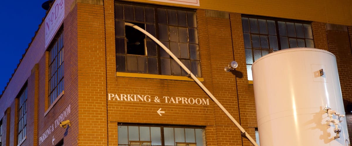 NoDa Brewing Company showing night scenes, signage and industrial elements