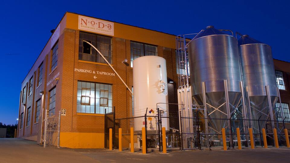 A brewery building with large silos and a sign reading "No-Da Brewing Company".