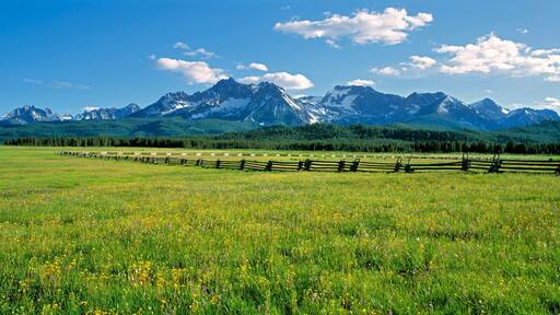 USA, Idaho, Sawtooth NRA. A split-rail fence extends to the Sawtooth Range at Sawtooth NRA, Idaho.