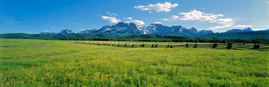 USA, Idaho, Sawtooth NRA. A split-rail fence extends to the Sawtooth Range at Sawtooth NRA, Idaho.