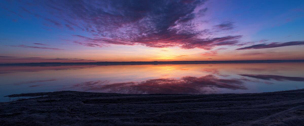 Next to the boat landing is a beach of shells