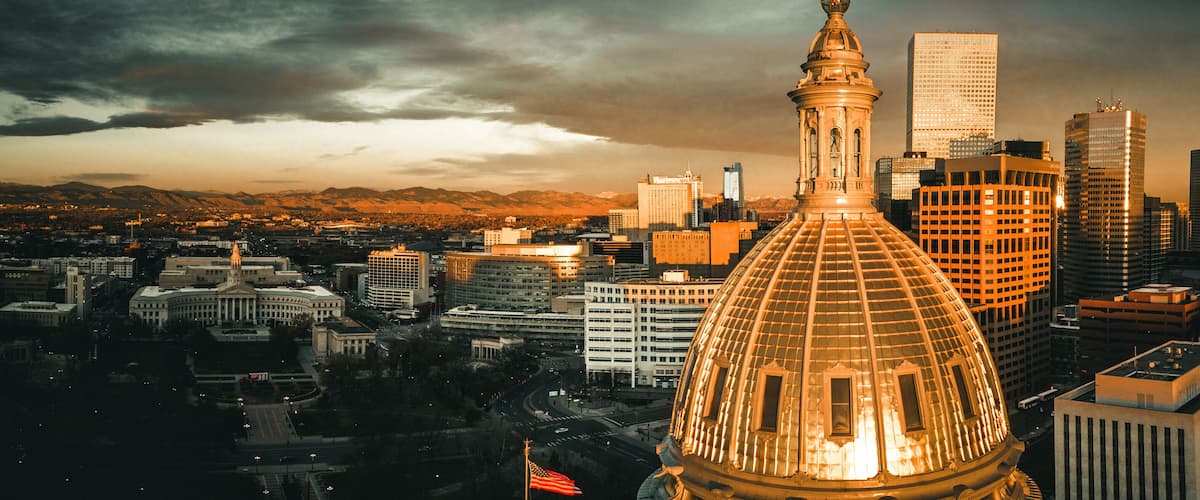 Aerial drone photo - Sunrise over the golden Colorado State Capitol Building. Denver