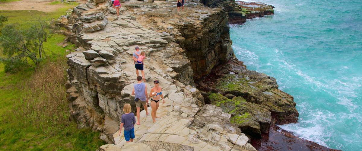 Yamba showing rugged coastline as well as a large group of people