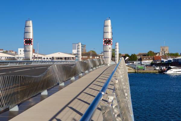 Poole showing a river or creek, a bridge and modern architecture