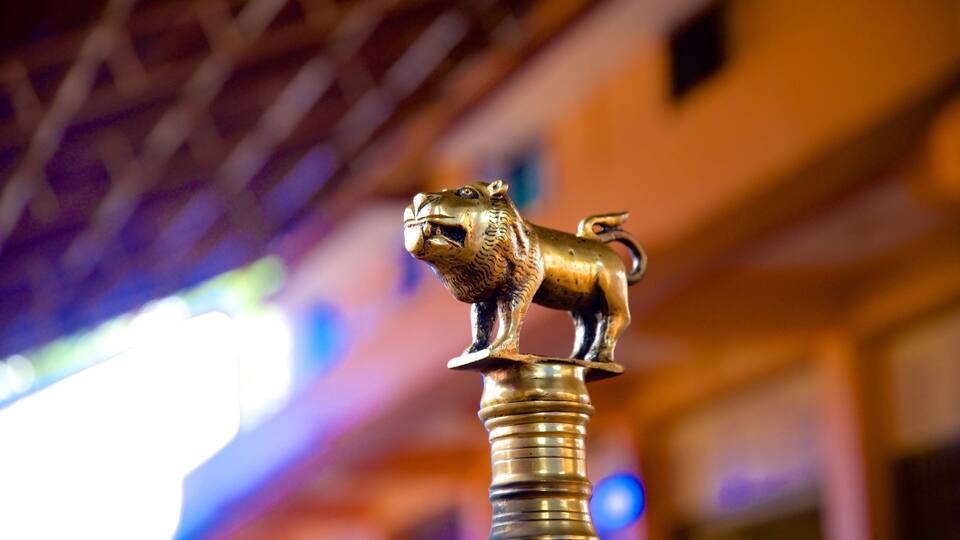 A golden lion statue mounted on a pillar.