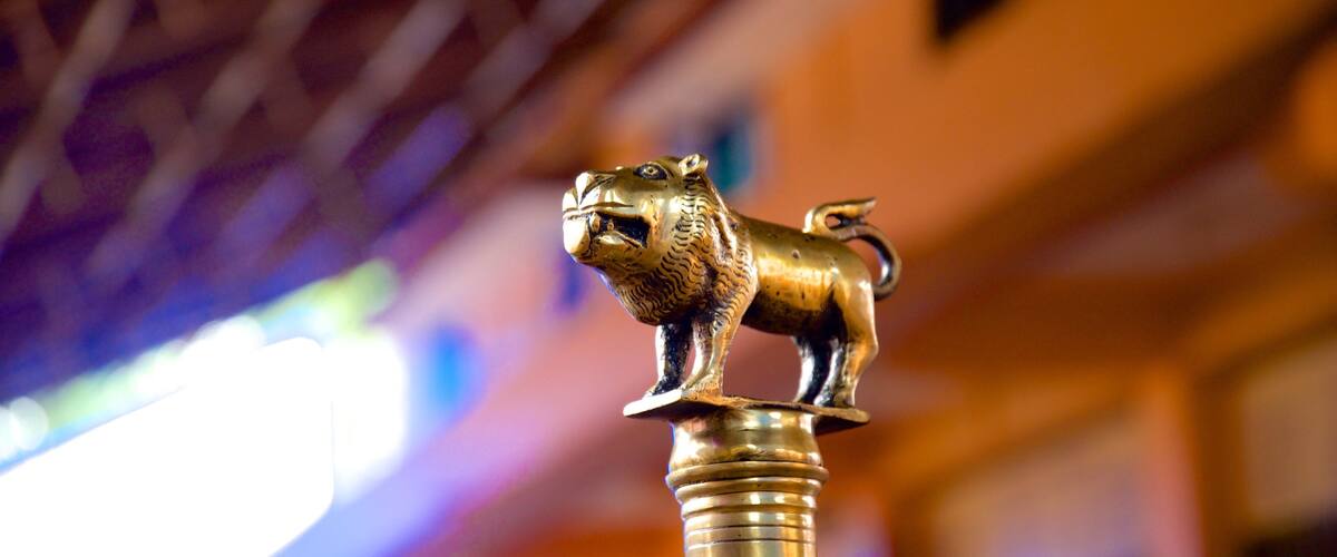 A golden lion statue mounted on a pillar.