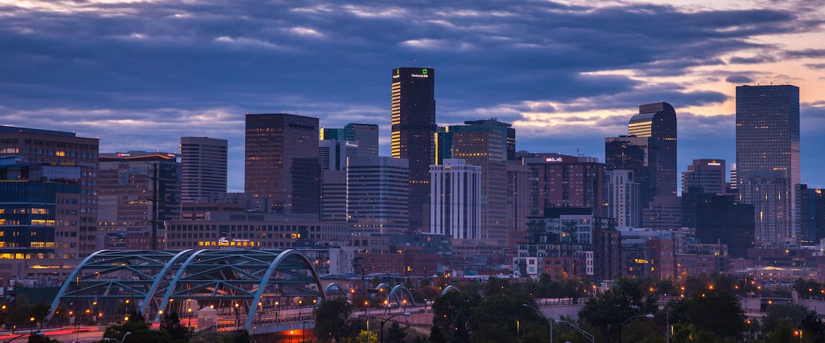 The skyline of Denver, CO at sunrise on a summer morning.