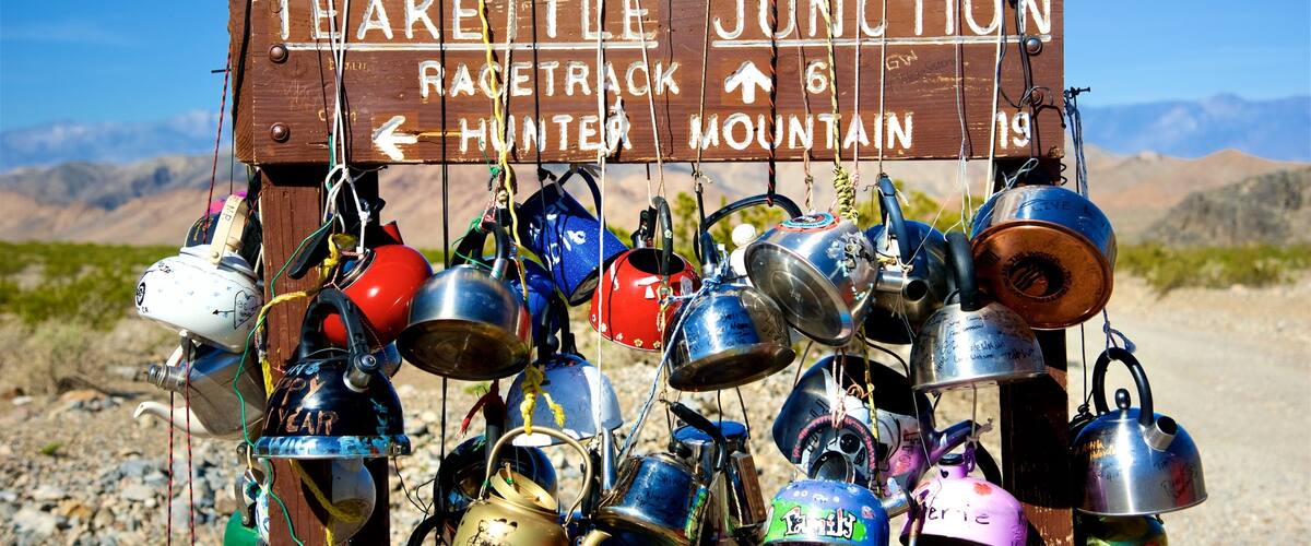 Death Valley featuring desert views, signage and heritage elements