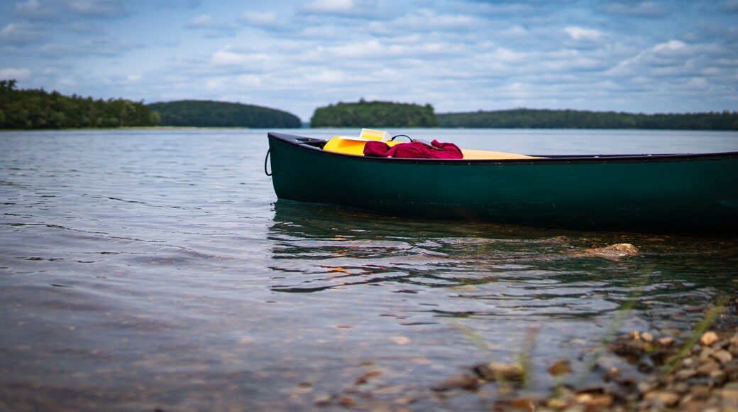 Green canoe ready for a lake paddle adventure