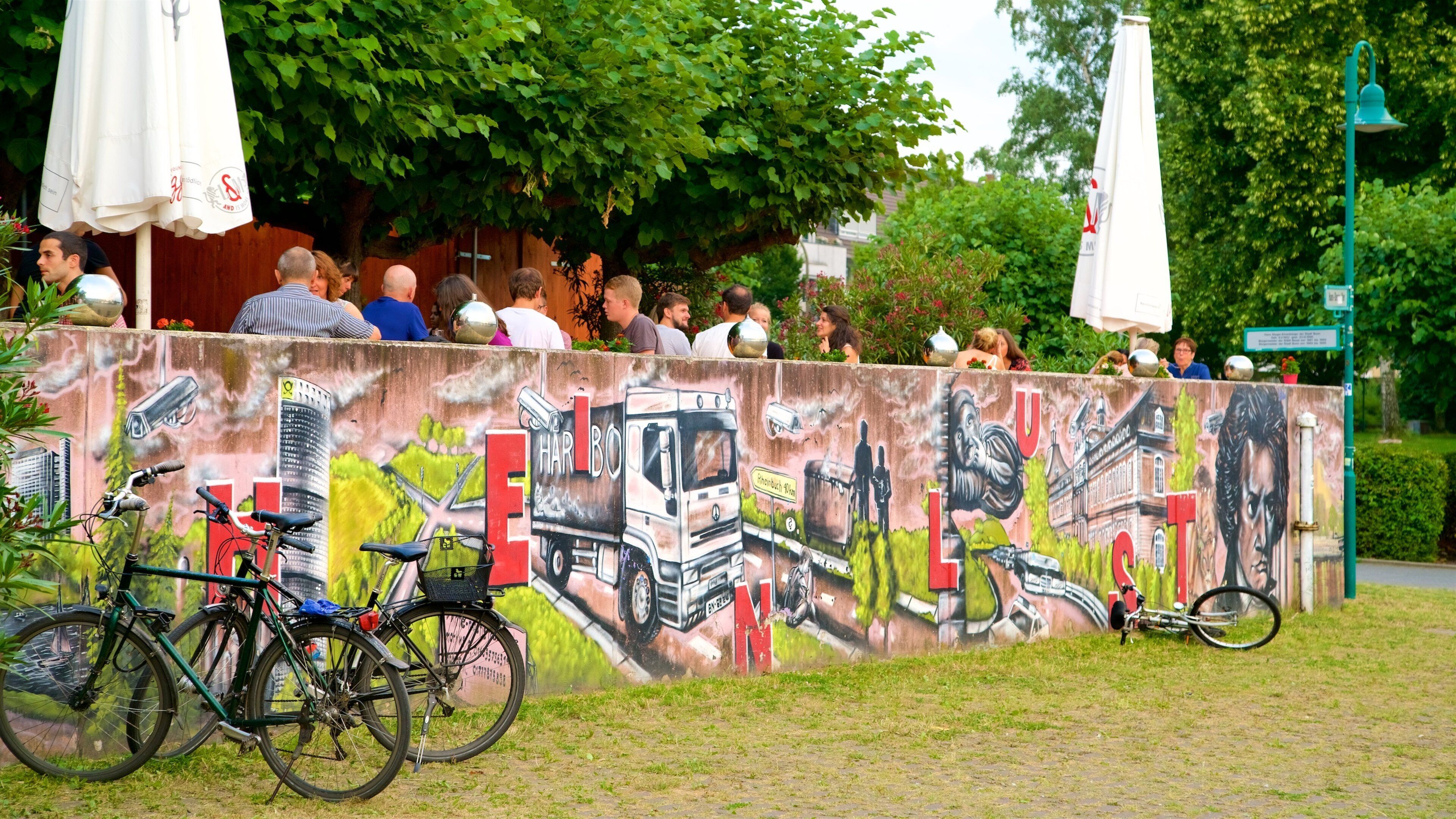 Kennedy Bridge showing outdoor art and outdoor eating as well as a small group of people