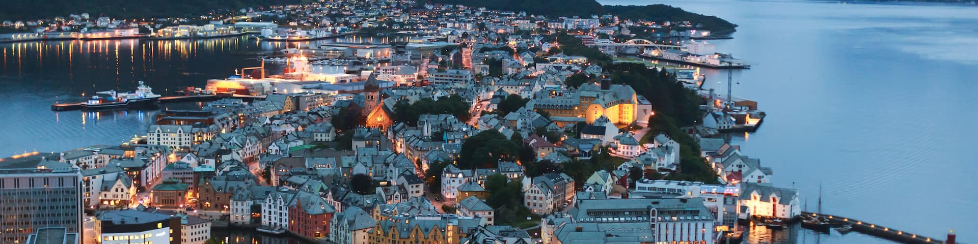Beautiful super wide-angle summer aerial view of Alesund, Norway, with skyline and scenery beyond the city, seen from the observation deck of Aksla mountain