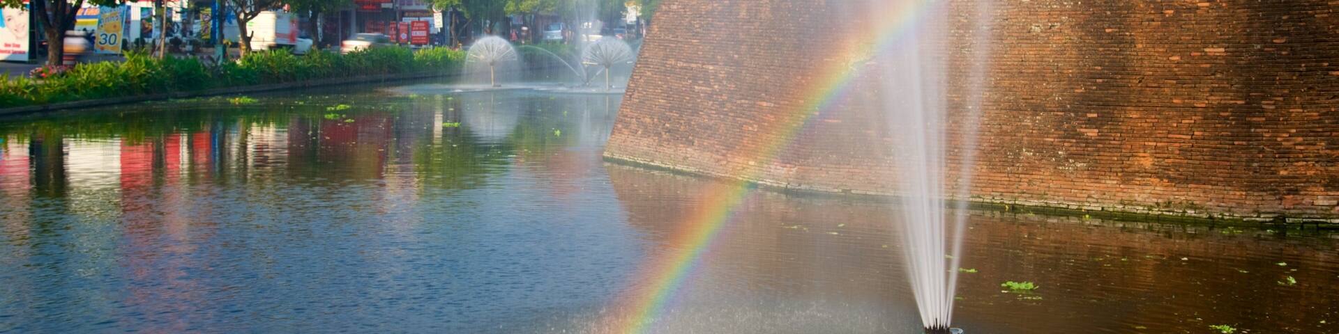 Une rivière aux couleurs de l’arc-en-ciel, une fontaine et un mur de briques.