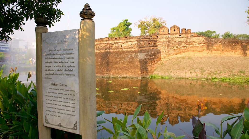 Chiang Mai showing a pond, building ruins and signage