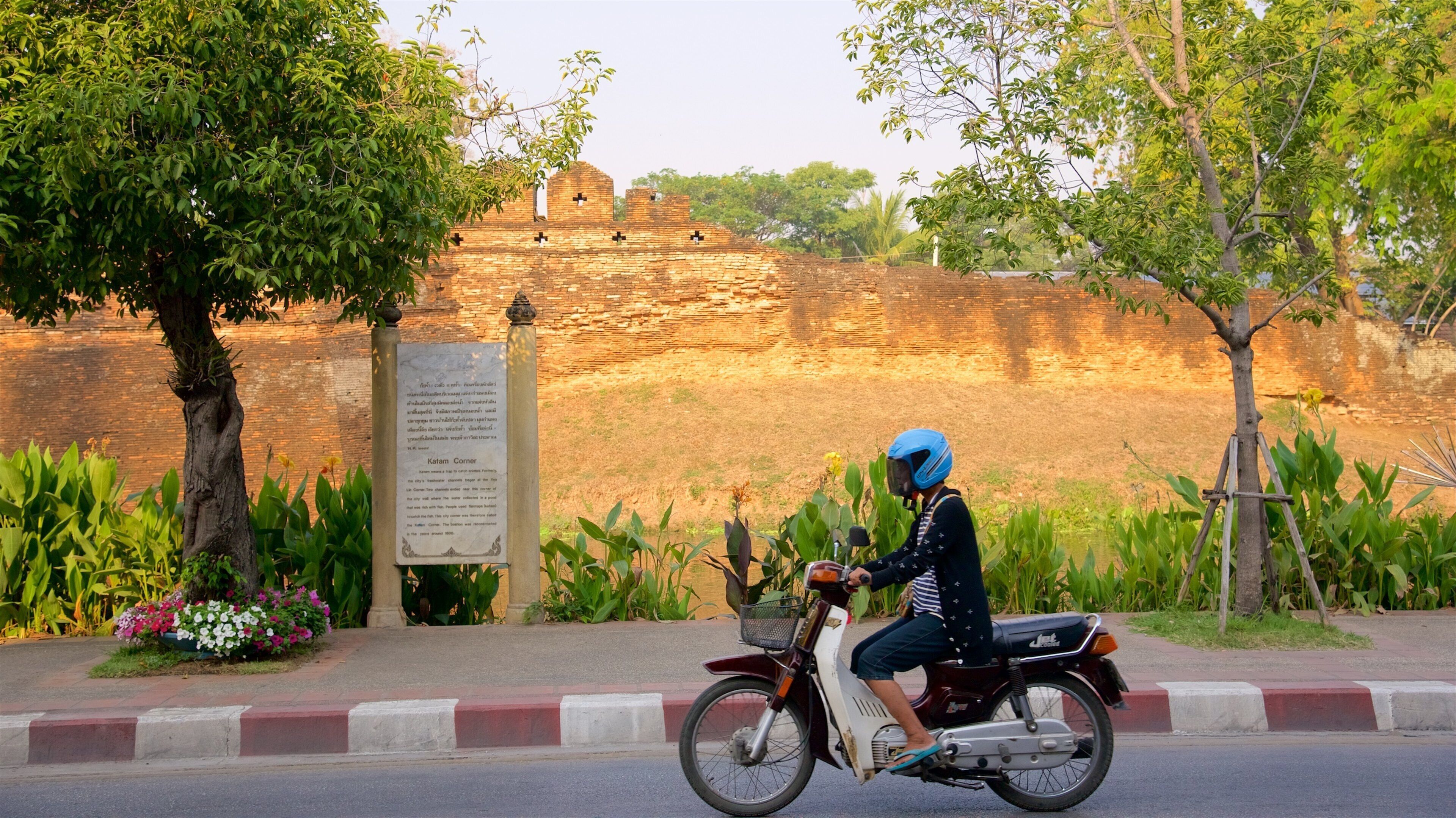 Katam Corner showing motorcycle riding as well as an individual femail
