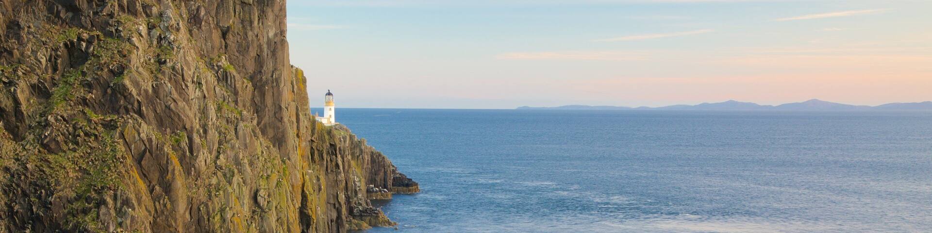 Isle of Skye featuring a lighthouse and rugged coastline