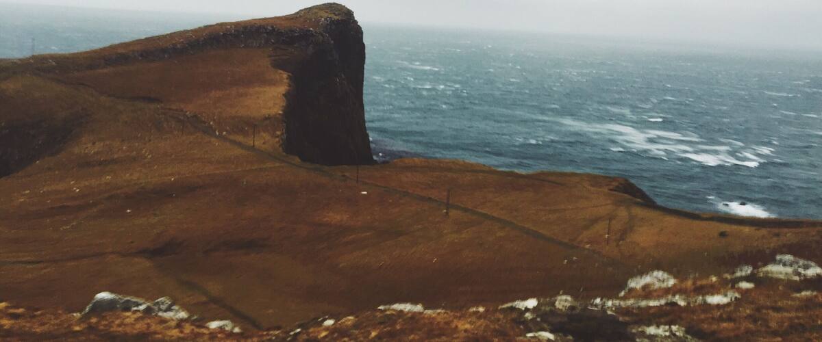 A rugged coastline with a prominent rock formation.