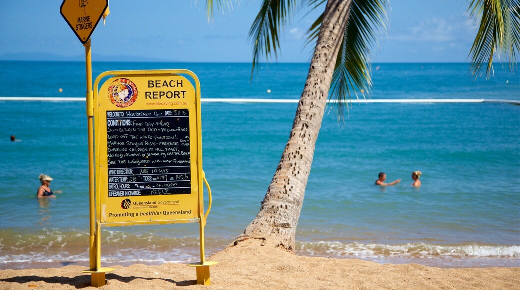 Horseshoe Bay Beach which includes general coastal views, signage and swimming