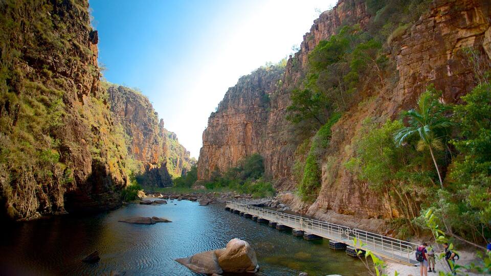A river canyon with rocky cliffs and a bridge.