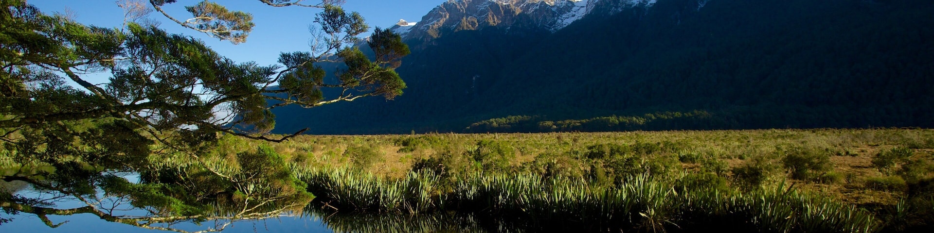 Mirror Lake showing a lake or waterhole, landscape views and a sunset