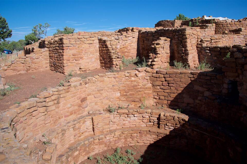 Ancient adobe ruins with a clear blue sky.
