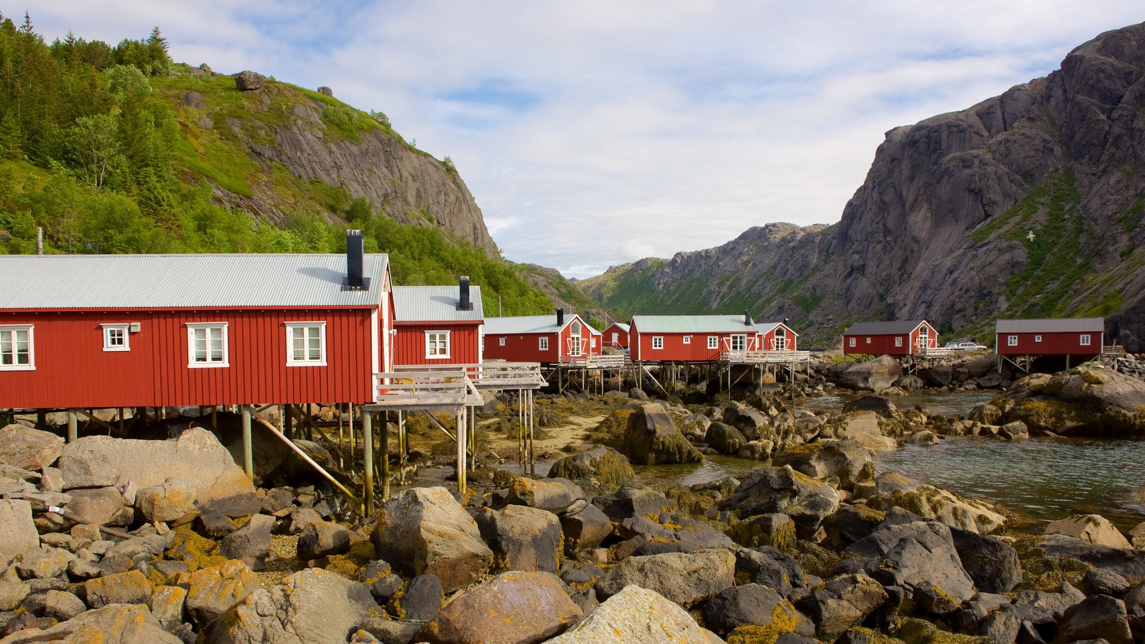 Nusfjord featuring a lake or waterhole, a small town or village and mountains