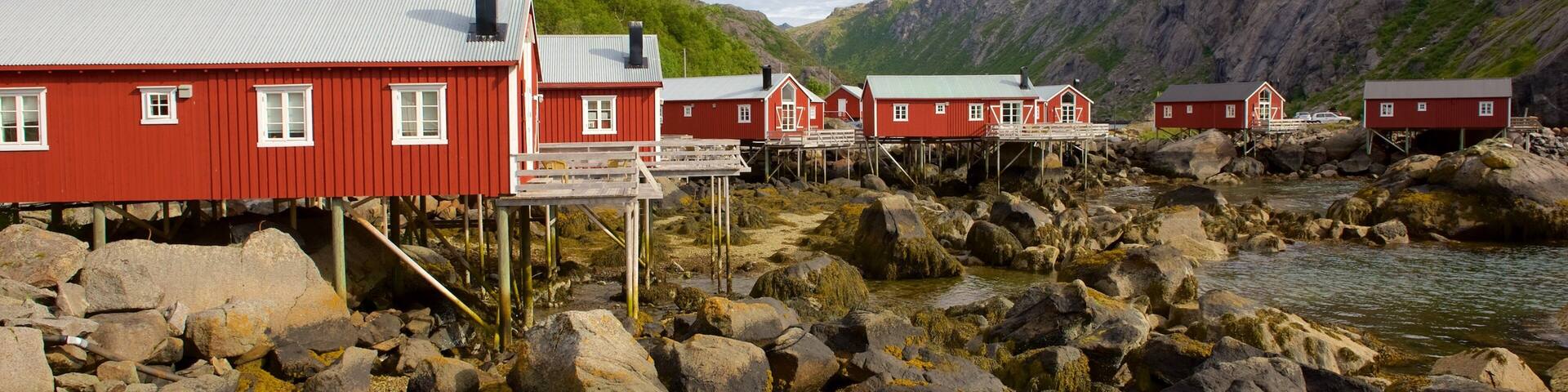 Nusfjord featuring a lake or waterhole, a small town or village and mountains